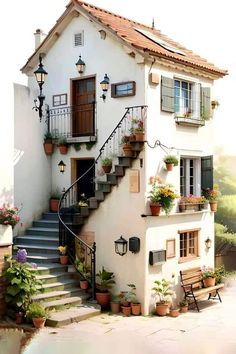 a white house with potted plants on the balcony and stairs leading up to it