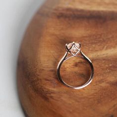 a diamond ring sitting on top of a wooden table