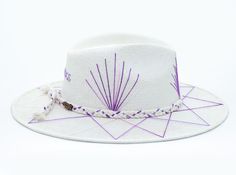 White Palm Straw Hat with Purple TCU Inspired Design on Brim by Corazon Playero. Custom designed and hand made hats by artisans in San Jose Del Cabo, Mexico. These hats are one size fits most with an elastic band inside to add comfort and fit for all head sizes. Each hat has a 3-4 week turnaround. Please note, all hats come with natural braid unless custom braid is purchased. Handmade White Bucket Hat, White Toquilla Straw Panama Hat For Festivals, White Handmade Fedora For Rodeo, Handmade White Fedora For Rodeo, White Artisan Hat With Short Brim, White Handmade Adjustable Panama Hat, Artisan White Hat With Short Brim, White Artisan Straw Hat With Short Brim, Artisan White Fedora For Festivals