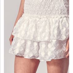 Textured. Flowy. Very Comfortable. White Ruffle Hem Skirt For Spring, White Tiered Bottoms For Spring, White Mini Skort With Ruffle Hem, White Ruffle Hem Mini Skort, Summer White Skirt With Ruffle Hem, White Ruffle Hem Skirt For Summer, White Flowy Skirt With Ruffle Hem, Flowy White Skirt With Ruffle Hem, White Tiered Bottoms For Day Out