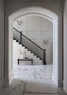 an entry way with marble floors and white walls