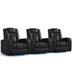 four black leather reclining chairs sitting next to each other on a white surface with blue lights