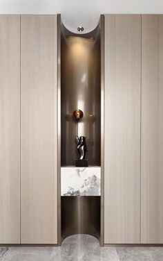 a modern bathroom with marble counter tops and wooden cabinetry, along with an oval sink