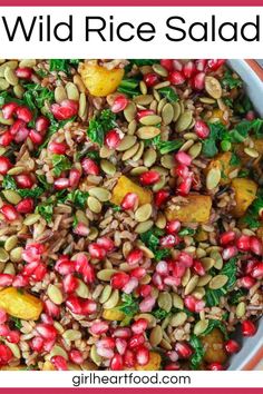 wild rice salad with pomegranates and kale in a white bowl