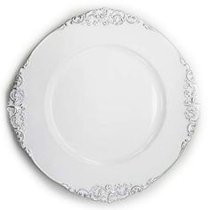 an empty white plate with ornate designs on the rim and bottom, against a white background