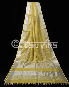 This elegant tissue linen drape in a beautiful gold tone features the beautiful and meticulously done floral cutwork design. This saree has pretty faux mirror (flattened sequin discs) work which adds a lovely vibe and bling to the whole outfit. The saree might have slight irregularities in the pattern & colors, which results from the human involvement in the process & is a hallmark of handcrafted products. Minor thread pulls are not considered damage. We recommend professional dry cleani Gold Tussar Silk Dupatta With Resham Embroidery, Gold Slub Silk Dupatta With Resham Embroidery, Gold Cotton Silk Dupatta With Gota Work, Gold Dupatta With Resham Embroidery In Slub Silk, Gold Cotton Silk Saree With Gota Work, Gold Dupatta With Resham Embroidery In Cotton Silk, Celebration Tussar Silk Saree With Gota Work, Tussar Silk Saree With Gota Work For Celebrations, Gold Slub Silk Traditional Wear With Chikankari Embroidery