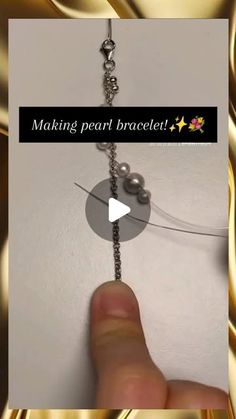 a person is making bead bracelets with pearls and beads on the end of a chain