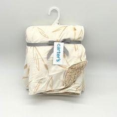 a folded cloth with a tag hanging from it's side on a white background