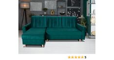 a green couch sitting in front of a gray wall