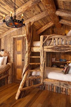 bunk beds made out of logs in a rustic cabin style bedroom with wood flooring