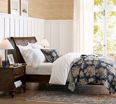 a bedroom with a bed, nightstands and lamps on the side of the room