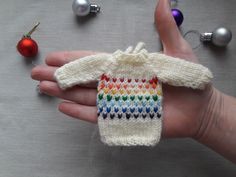 "Dress up your tree in style with this adorable Christmas sweater! Miniature handmade sweater made of semi-wool. Dimensions: Height 3.3 \"(8cm) Width (including sleeves) 5.5\" (14cm). As it is handcrafted, the size may vary slightly. The sweater has a drawstring for hanging, if necessary, it can be hidden inside. What's in the package: 1 handmade mini sweater, shipping box. Color may vary slightly due to different monitor colors. Check out other mini sweater designs: https://www.etsy.com/shop/Kn Cozy Winter Sweater Gift, Cozy Winter Sweater For Gift, Cozy Winter Sweater As Gift, Cute Winter Sweater As A Gift, Cute Long Sleeve Sweater For Gift, Winter Gift Knitting Pattern, Knitted Long Sleeve Sweater Gift, Knitted Long Sleeve Sweater As Gift, Handmade Sweater As Winter Gift