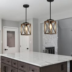 two lights hanging over a kitchen island in a home