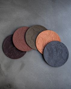 four coasters with different patterns on them sitting next to each other in a circle