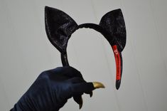 "Cat Costume ears and gloves. Cat ears made from black stretch lurex and attached to comfortable lurex covered headband. Ear shape to replicate original costume as worn by Julie Newmar. Opera length black spandex gloves with long gold nails/talons will have you saying 'Meeooow\" with Purrfection. Please inquire about black lurex catsuit. Available in sizes 2-16 Necklace not available at this time PLEASE ALLOW 4-6 WEEKS FOR LYNNE TO MAKE YOUR ITEMS. THE GLOVES WITH NAILS ARE CURRENTLY UNAVAILABLE Long Gold Nails, Gloves With Nails, Julie Newmar, Accessories Ear, Cat Costume, Cat Mask, New Year's Nails, Cat Costumes, Costume Hats