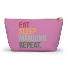 a pink zipper bag with the words eat sleep mahiong repeat