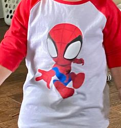 Red & White Toddler Baseball Shirt with Spidey on front and web on back. This cute baseball t-shirt features a white center with bright red half sleeves and collar.   100% Cotton Machine wash warm; tumble dry low; non-chlorine bleach when needed.  Iron inside out if needed. Sporty Red T-shirt With Raglan Sleeves, Red Cotton Baseball Jersey For Baseball Season, Playful Red Character Print T-shirt, Casual Red Crew Neck Baseball Jersey, Red Short Sleeve Baseball Jersey With Letter Print, Red Cotton Casual Baseball Jersey, Casual Red Cotton Baseball Jersey, Playful Red T-shirt With Character Print, Sporty Red Tops For Baseball Season