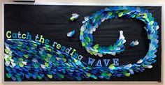 a bulletin board with blue and green confetti in the shape of a wave