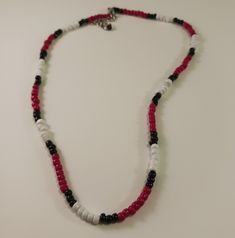 This is a seed bead necklace made in the Southwest style.  The colors are red, black and white.  The necklace is 18 1/2 inches in length and has a 2-inch extension chain. Hippy style necklace. Casual Red Tiny Beads Necklace, Casual Red Beaded Necklace With Tiny Beads, Red Beaded Necklaces With Letter Beads, Black Necklaces With Round Letter Beads, Casual Red Round Beaded Necklaces, Red Beaded Necklace With Letter Beads, Casual Red Beaded Necklace, Red Beaded Necklace With Letter Beads For Jewelry Making, Red Necklaces With Round Letter Beads