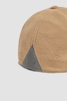 a tan hat with grey details on the side