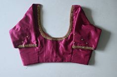 Beetroot pink kanchipuram silk blouse with beautiful hand emb (aari ) done with golden beads and stones. It can be customized to any colour and  size. Pl leave a msg for customization. Product colour may slightly vary due to photographic lighting sources or your device settings. For customization i will send you the measurement chart which you can fill and send it back to me . I ship to all places except germany. Standard shipment takes 30 working days  Speed takes 20 working days . Express takes 5 working days Traditional Drape Blouse In Dola Silk With Gota Work, Pink Chanderi Blouse Piece With Gota Work, Silk Gota Work Blouse For Wedding, Silk Blouse With Gota Work For Wedding, Gold Blouse Piece With Gota Work For Puja, Silk Wedding Blouse With Gota Work, Festival Dola Silk Blouse With Gota Work, Traditional Dola Silk Blouse With Gota Work, Art Silk Blouse With Gota Work For Festivals