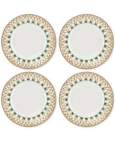 four white and green plates with gold trim