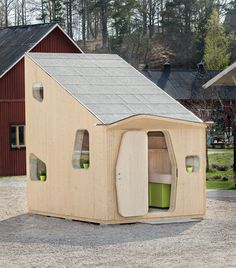 an outhouse is shown in the middle of a gravel lot