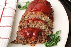 meatloaf on a plate with ketchup and parsley