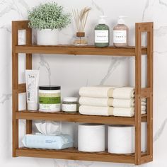 the shelf is holding several different types of towels and body care products, including handmade soaps