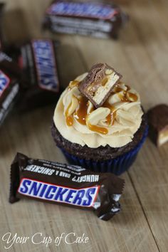 a cupcake that is sitting on top of a table next to a candy bar