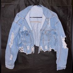 Ripped Jean Jacket With Cuffed Sleeves Eight Buttons, All Intact And In Good Condition Never Worn Size Extra Small 85% Cotton, 15% Polyester Ripped Long Sleeve Outerwear For Streetwear, Trendy Ripped Winter Outerwear, Ripped Long Sleeve Outerwear For Winter, Winter Ripped Long Sleeve Outerwear, Ripped Cropped Fall Outerwear, Ripped Cropped Outerwear For Fall, Cropped Ripped Outerwear For Fall, Trendy Blue Denim Jacket With Zipper Closure, Trendy Blue Denim Jacket With Zipper