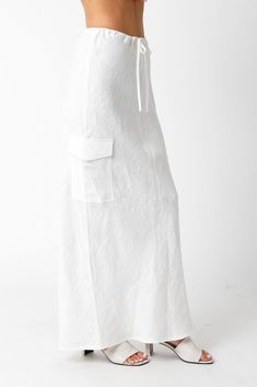 The Kaia White Linen Cargo Maxi Skirt is the perfect vacation cover-up! White linen woven fabric shapes this cargo maxi skirt with a mid-rise fit and drawstring tie. Style with sandals and a cute top and wear to dinner! DETAILS & FIT Loose Fit. 100% Linen. Machine wash cold. Imported. Beach Linen Maxi Skirt, Linen Maxi Skirt For The Beach, Spring Vacation Maxi Skirt With Drawstring, Chic Summer Maxi Skirt With Drawstring, Summer Maxi Bottoms For Day Out, Summer Drawstring Relaxed Fit Skirt, Vacation Skirt With Drawstring, Relaxed Linen Maxi Skirt For Vacation, Summer Vacation Maxi Skirt With Drawstring