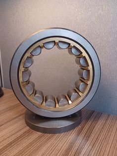 a close up of a ball bearing unit on a table with a wall in the background