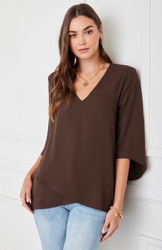 An elegant top of silky, lightweight crepe delivers elegant movement with its angled flare sleeves and fluttery asymmetrical hemline that dips low in back. 25 1/2" length (size Medium) V-neck Three-quarter sleeves Back yoke with gathering Crossover high/low hem 100% polyester Dry clean or hand wash, line dry Made in the USA of imported fabric Women's Clothing Chic Viscose Top With Asymmetrical Hem, Chic Viscose Tops With Asymmetrical Hem, Chic Flowy Blouse With Asymmetrical Hem, Drapey Tops With Asymmetrical Hem For Spring, Spring Drapey Top With Asymmetrical Hem, Chic Asymmetrical Drapey Tops, Elegant Flowy Rayon Tops, Elegant Asymmetrical Drapey Tops, Elegant Rayon Tops For Layering