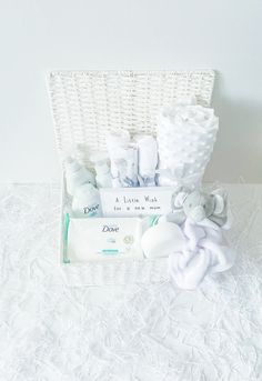 a white wicker basket filled with baby items