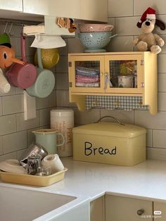 a kitchen counter topped with lots of different types of dishes and toys on top of it