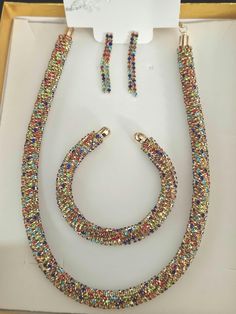 A beautiful  elegant gold multi colour rhinestone rope twist necklace set very trendy and eye catching  BRACELET and necklace IS MORE SUITABLE FOR SOMEONE WITH SMALLER HANDS  and neck EVEN THOUGH IT HAS A OPEN TO IT  Length of necklace 18 inches Earring 2 inches Open cuff bracelet 7 inches Glamorous Multicolor Wedding Jewelry, Multicolor Rhinestone Necklace With Sparkling Stones For Party, Party Multicolor Bling Jewelry, Multicolor Metal Rhinestone Necklace For Party, Elegant Multicolor Rhinestone Necklace With Bling, Multicolor Crystal Jewelry Sets For Parties, Multicolor Crystal Jewelry For Evening, Party Multicolor Rhinestone Necklace, Multicolor Crystal Beaded Jewelry