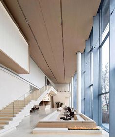 the interior of a modern building with large windows and staircases leading up to it