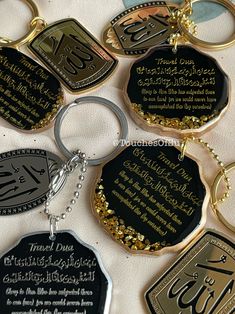 six different types of key chains with arabic and english writing on them, all in various colors