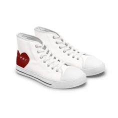 a pair of white sneakers with red hearts on them