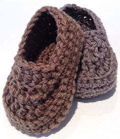 two crocheted baby booties sitting next to each other