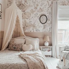 a bedroom with floral wallpaper and canopy bed