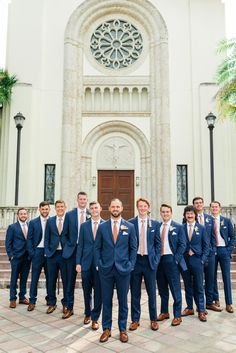 a group of men standing in front of a church