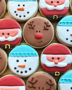 decorated cookies with santa claus and reindeer faces on them are arranged in the shape of snowmen