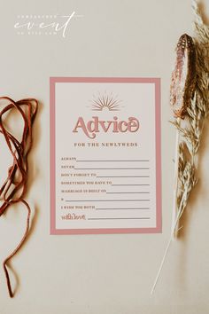 a pink advice card next to some dried flowers and twine on a white surface