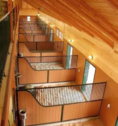 the inside of a building with wooden walls and flooring is lit up by lights