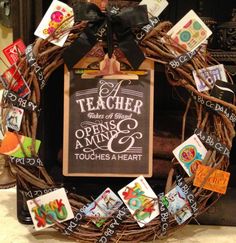 a wreath made out of branches with magnets on it and a teacher sign in the middle