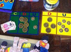 a child's play area with money and toys on the floor, including coins