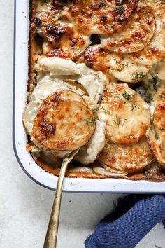 cheesey scalloped potatoes with mushrooms and dill in a casserole dish