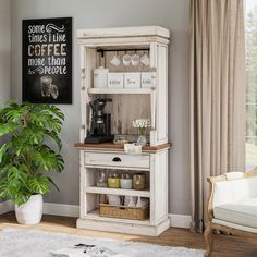 a white cabinet sitting in a living room next to a potted plant